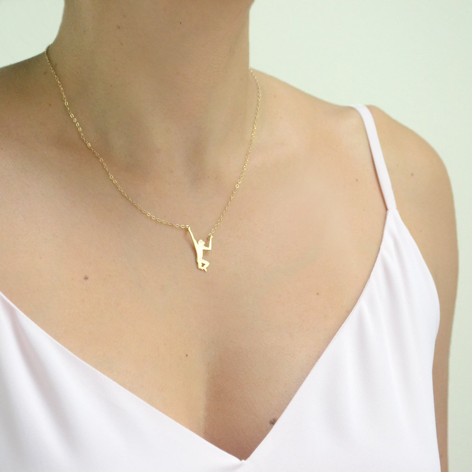 gold monkey necklace worn