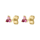 Trio of ruby and pink sapphire stud earrings in 14k yellow gold